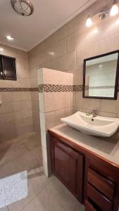a bathroom with a sink and a mirror at Manuel Antonio Inn CR in Manuel Antonio