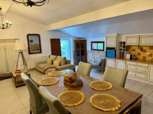 a kitchen and living room with a table and chairs at Maison à la campagne. in Sollacaro