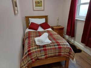 リポンにあるCharming 2-Bed Cottage in Riponのベッドルーム1室(ベッド1台、タオル2枚付)