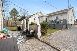 a house with a yard with chairs and a fence at Southbound Stays - Little House in Nashville