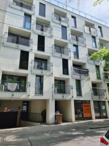 an apartment building with balconies on a city street at Apartman - Centrum in Bratislava