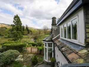 a house with windows and a view of the countryside at River Lodge in Ambleside