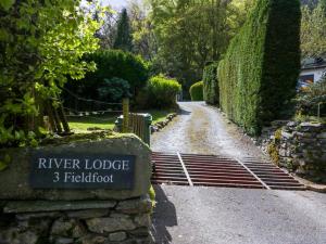 a gate to a garden with a river lodge fieldord at River Lodge in Ambleside