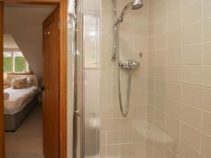 a bathroom with a shower with a glass door at River Lodge in Ambleside +57 photos