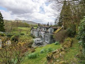 an old house in the middle of a field at River Lodge in Ambleside