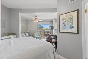 a bedroom with a bed and a dining room at Lei Lani Village 112 by Vacation Homes Collection in Orange Beach