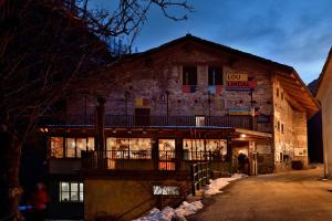a building with a sign that reads top inn at Rifugio Lou Lindal in Canosio
