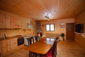 a kitchen and dining room with a table and chairs at Shpija Ujevara e Vogel in Theth