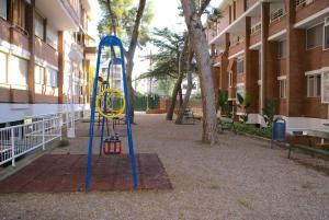 a playground in front of a building at Sun pool duplex apartment by HLCLUB Agency in Vilanova i la Geltrú