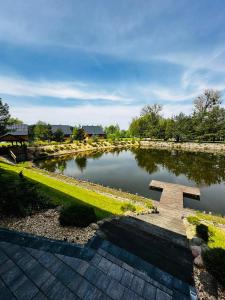 a pond with a bench in the middle of it at Kamienica House 9 in Wągrowiec