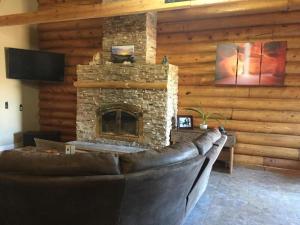 a living room with a couch and a fireplace at Ponderosa Inn in Escalante