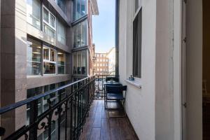 a balcony with chairs and a view of a city at Urban Rooms in Budapest