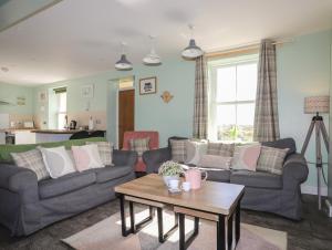 a living room with two couches and a coffee table at Tregynrig Bach in Cemaes Bay