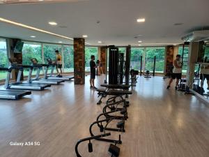 a gym with a row of treadmills and people in it at Laghetto Golden Resort in Gramado