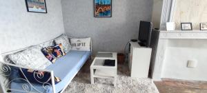 a small bedroom with a bed and a tv at Céline et José in Cubzac-les-Ponts