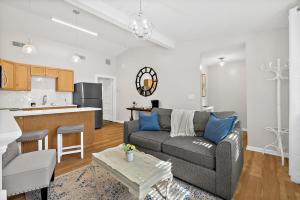 a living room with a couch and a kitchen at Cozy Uptown Guest House in St. Augustine