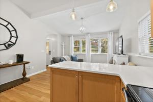 a kitchen with a large clock on the wall at Cozy Uptown Guest House in St. Augustine +17 photos