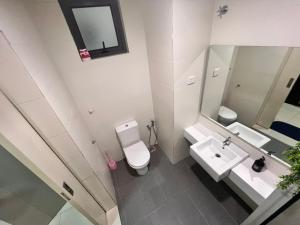 a bathroom with a toilet and a sink and a mirror at BLUE JADE STUDIOS in Tanah Rata