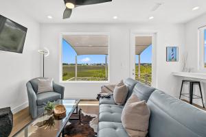 a living room with a couch and a table at 200 Riberia - Downtown Waterfront Luxury Home in Saint Augustine