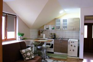 a small kitchen with a table and a counter at Svila Apartmani in Bihać