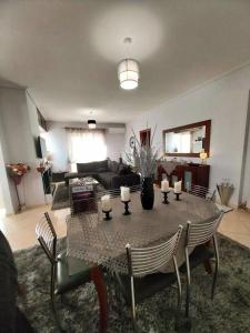 a living room with a table with candles on it at Thira Apartment near Athens Airport in Spáta