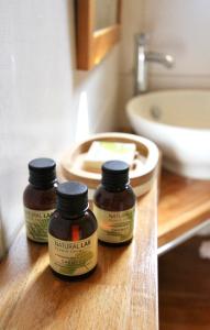 two bottles of herbal jar on a wooden counter in a bathroom at studio, vue sur mer et montagne in Saint-Florent