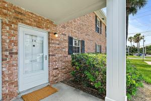 a brick house with a white door in front at Island Suite - Walk to Downtown! in Saint Augustine