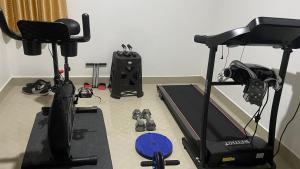 a room with a treadmill and a bike and a gym at NEST Mdy in Mananthavady