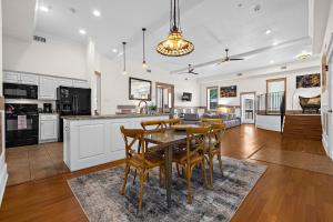 a kitchen and living room with a table and chairs at The Ray - 2nd Floor Historic Condo- Minutes Walk to Downtown in Saint Augustine