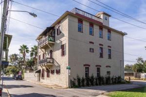 a large white building on the side of a street at The Ray - 2nd Floor Historic Condo- Minutes Walk to Downtown in St. Augustine