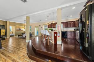 een keuken en een woonkamer met houten vloeren bij The Ray - Penthouse Suite - 360° Rooftop View in St. Augustine