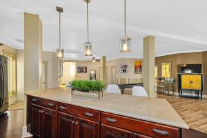 a large kitchen with a large island in the middle at The Ray - Penthouse Suite - 360° Rooftop View in St. Augustine
