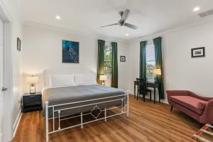 um quarto com uma cama e um sofá em Luxury New 3BD Home with Parking and Private Yard em Nova Orleans