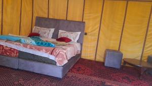 a bedroom with a bed in a tent at camp erg znaigui in Taouz