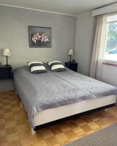 a bedroom with a bed with two pillows on it at Tahkontilhi in Kuopio +11 photos