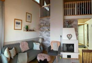 a living room with a couch and a fireplace at Tahkontilhi in Kuopio