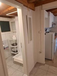 a kitchen with a sink and a refrigerator at Robinson house Sea & olives in Tisno +9 photos