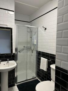 a bathroom with a shower and a toilet and a sink at Gogartys Temple Bar Apartments in Dublin