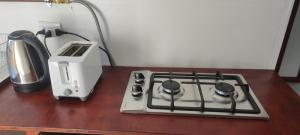 a stove top and a toaster sitting on a table at Cabañas en la naturaleza in Villarrica