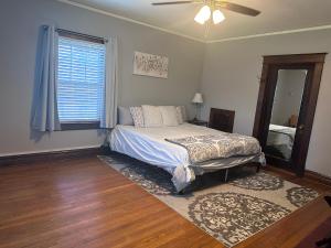 a bedroom with a bed with a fan and a window at The Manor at Glen Jean Meadows in Oak Hill