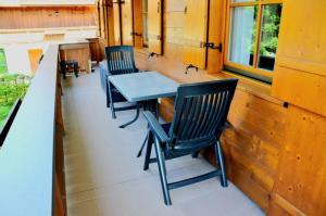 a table and chairs on the porch of a house at Sonnenwinkl in Reit im Winkl