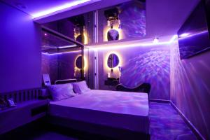 a room with a bed with purple lights at Motel Messalina in Sao Paulo