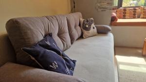 a couch with pillows on it in a living room at Chalet Mila in Mavrovo