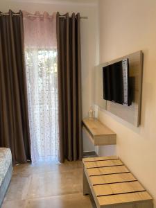 a living room with a flat screen tv on a wall at Soula Apartments & Studios in Palaiochora