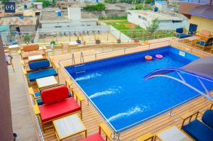 a swimming pool on a cruise ship with colorful chairs at Residence in Abomey-Calavi