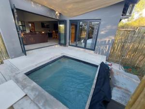 a swimming pool in the middle of a house at House UmGanu in Marloth Park