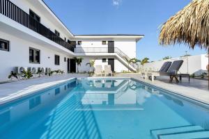 a swimming pool in front of a house at Villa Valena Apartment 9 with Cooling Pool in Kralendijk