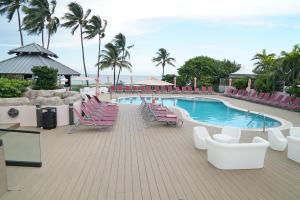 a swimming pool with lounge chairs and a swimming poolvisorvisor at Oceanview Apartment on the beach 123 in Miami Beach