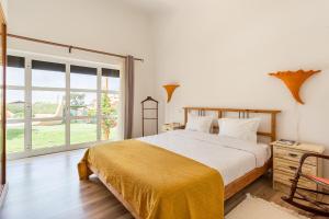 a bedroom with a bed and a large window at Casa do Vale in Chelreira +96 photos