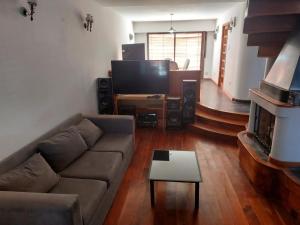 a living room with a couch and a television at Ticas in General Roca